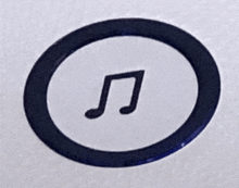 a black circle with a music note in it