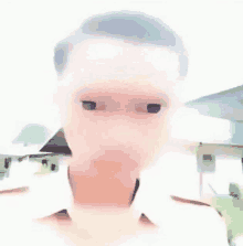 a blurry picture of a man 's face with a white shirt on