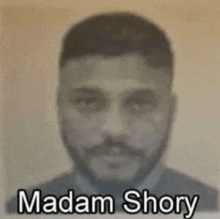 a black and white photo of a man with the name madam shory written on it .