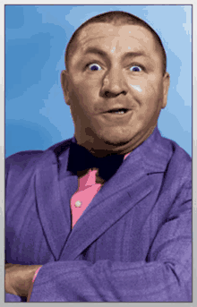 a man wearing a purple suit and a pink shirt