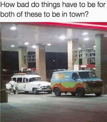 a ghostbusters van and a scooby doo van are parked next to each other at a gas station