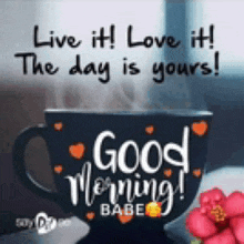 a cup of coffee with the words `` live it ! love it ! the day is yours ! '' written on it