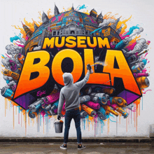 a man is spray painting graffiti on a wall for the museum bola