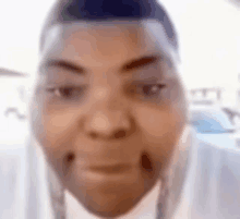 a close up of a man 's face with a white shirt on .