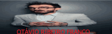 a man with glasses and a beard has the name otavio ribeiro franco written in red