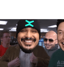 a man with a beard wearing a beanie with a x on it