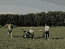 a group of people playing instruments in a field with a drum set that has the letter y on it