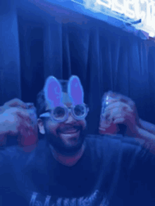 a man wearing bunny ears glasses holds a can of soda