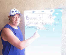 a man giving a thumbs up in front of a board that says buondi