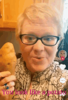 a woman with glasses is holding a potato with the words " you look like a potato " above her