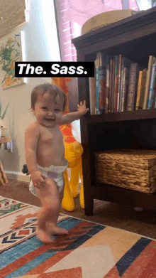 a baby in a diaper is standing in front of a bookshelf with the words " the sass " written on it