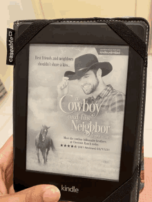 a person is holding a kindle with a book called a cowboy and his neighbor on it