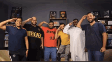 a group of men are posing for a picture with one wearing a bbva jersey