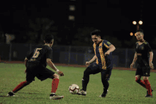 a soccer player wearing a blue and yellow jersey with the number 5 on it