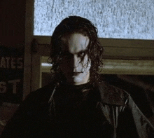 the crow from the crow movie is wearing a black leather jacket and a black shirt .