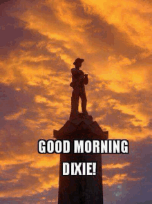 a statue of a soldier on top of a tower with the words good morning dixie written below it