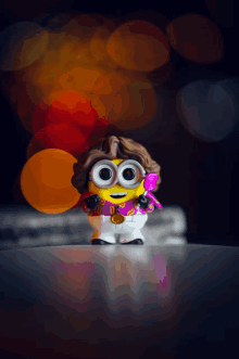 a toy minion with a purple shirt and a comb