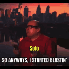 a man in a red shirt is holding a remote control and says solo so anyways , i started blastin '