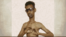 a shirtless man wearing sunglasses makes a heart with his hands