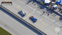 an aerial view of two race cars going down a road with a sign that says road america race 1 lap 40 of 55