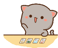 a cat is sitting at a table with cards on it