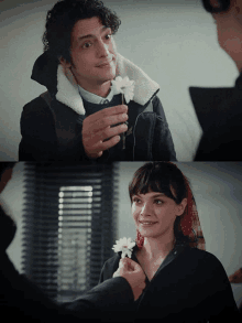 a man is giving a woman a flower and she is smiling