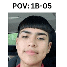 a young man with a very short haircut is sitting in a car and smiling .