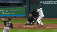 a baseball game is being played in front of an advertisement for progressive