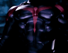 a close up of a person 's back in a superhero costume in a dark room .