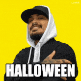 a man wearing a hoodie and a hat with the word halloween written on it