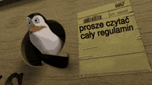 a penguin sits next to a piece of paper that says prosze czytac caly regulamin