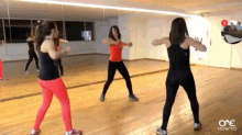 a group of women are dancing in front of a mirror with one how to written on the bottom right