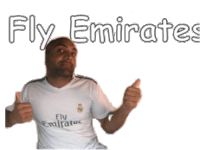 a man is wearing a fly emirates shirt and giving a thumbs up