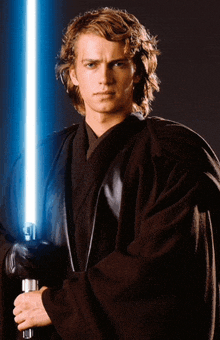 a man in a black robe is holding a blue lightsaber