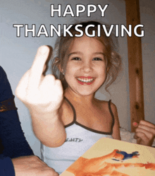 a little girl is giving the middle finger and the words happy thanksgiving are above her