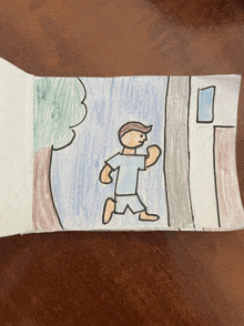 a child 's drawing of a man running on a wooden table