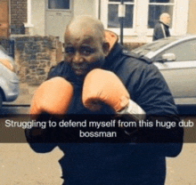 a man wearing boxing gloves is struggling to defend himself from a dub bossman