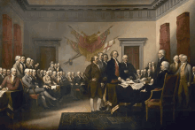 a group of men are gathered in a room with a flag on the wall