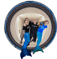 a group of people are posing in front of a circle that says indoor skydiving.com