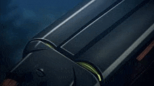 a close up of a black object with a yellow stripe on it in a dark room .