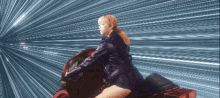 a woman in a black leather jacket is sitting on a red motorcycle