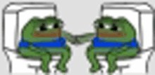 two frogs are sitting on a toilet shaking hands .