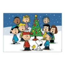 a group of peanuts characters standing around a christmas tree .