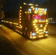 a red truck with mustafa written on the front