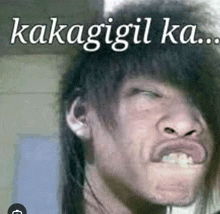 a man with long hair making a funny face with the words kakagil ka