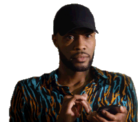 a man wearing a hat and a zebra print shirt holds a cell phone