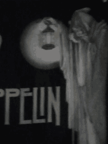 a black and white photo of a statue with the word zeppelin written on it