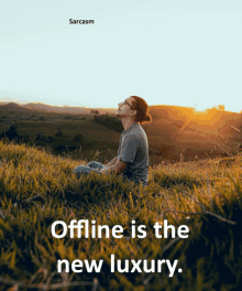 a man is sitting in the grass with a caption that says sarcasm offline is the new luxury