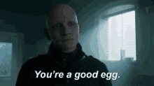 a bald man in a black jacket says " you 're a good egg "