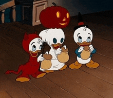 three cartoon ducks are dressed up in costumes for halloween and standing next to each other on a wooden floor .